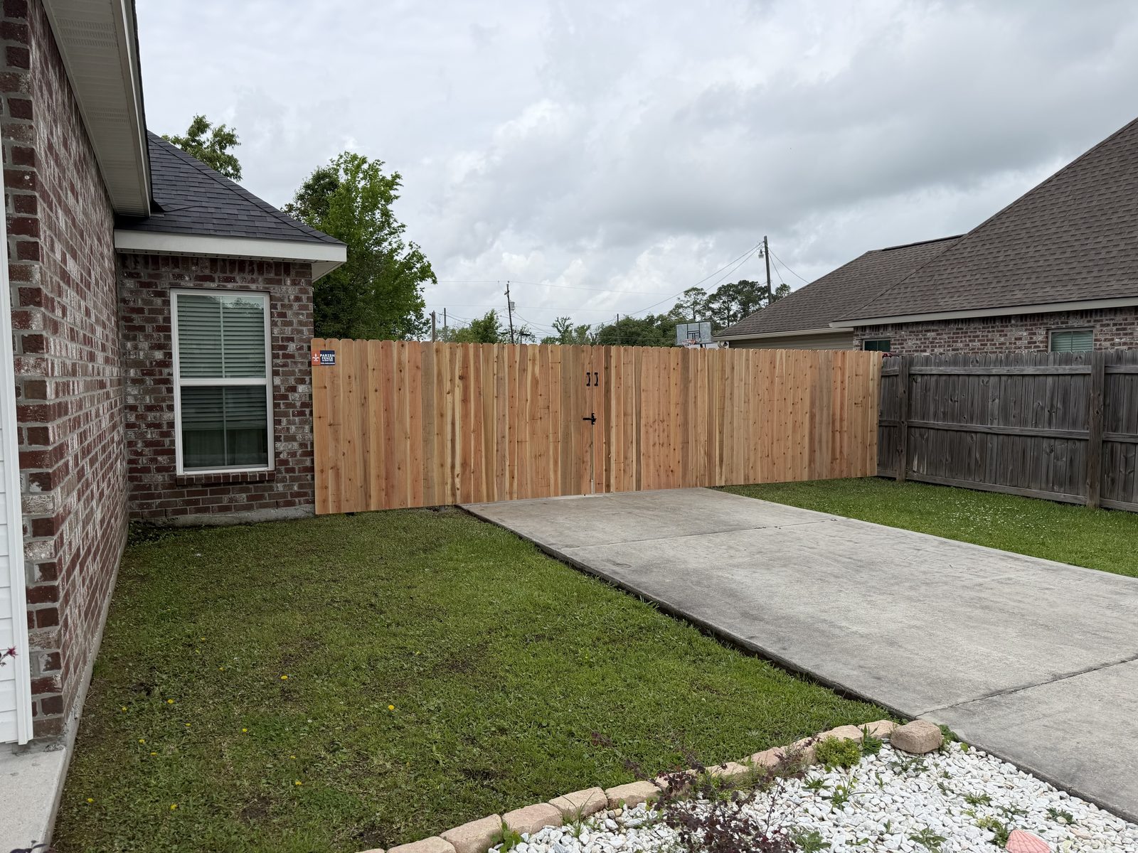 Cedar double drive gate on steel posts