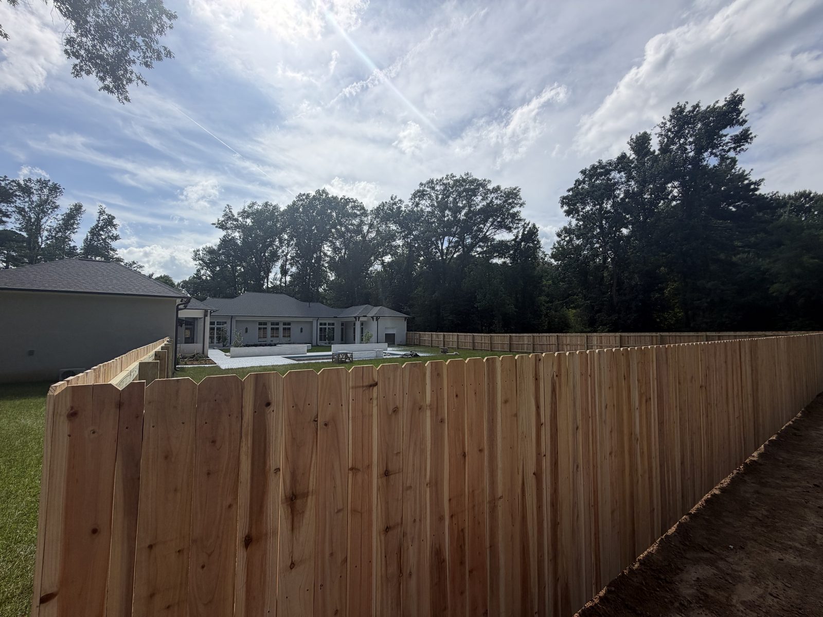 Cedar privacy fence around a new build