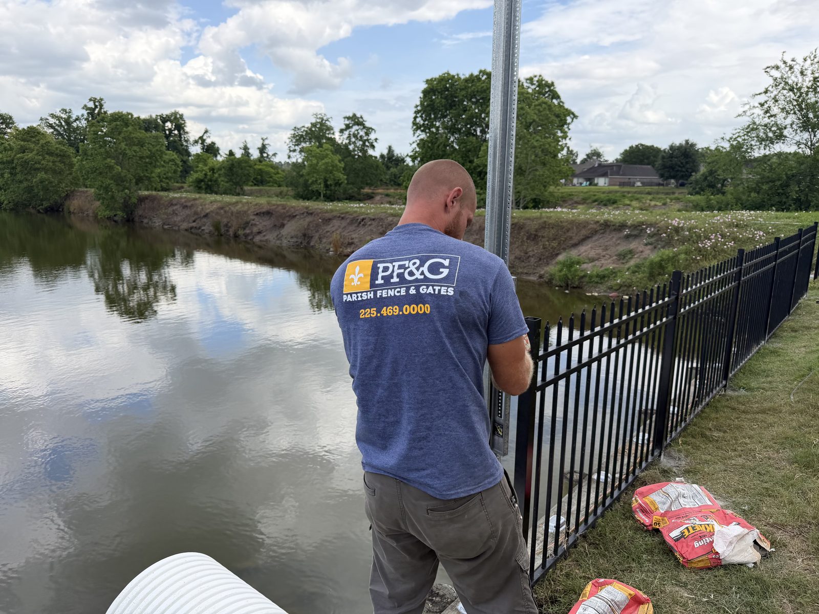 Parish crew setting aluminum fence posts along the Diversion Canal