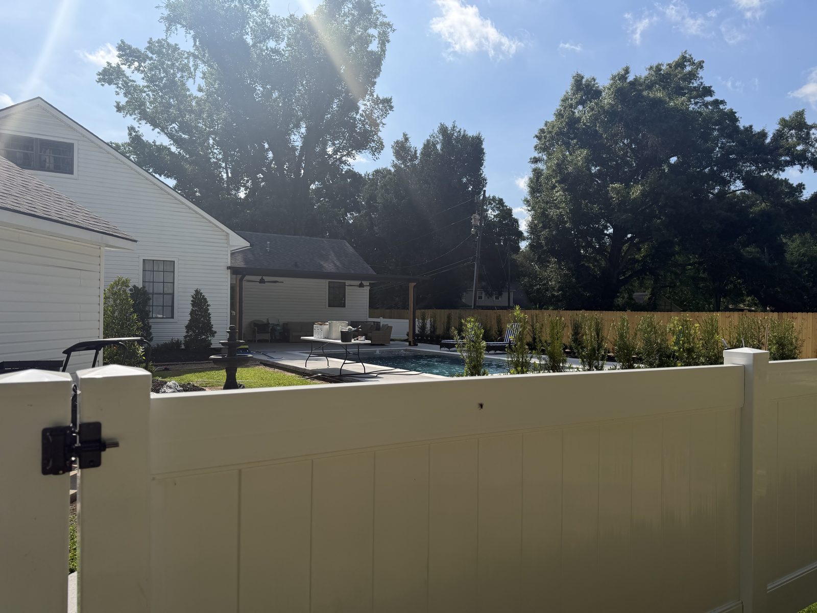 Vinyl privacy fence and gate around a pool yard