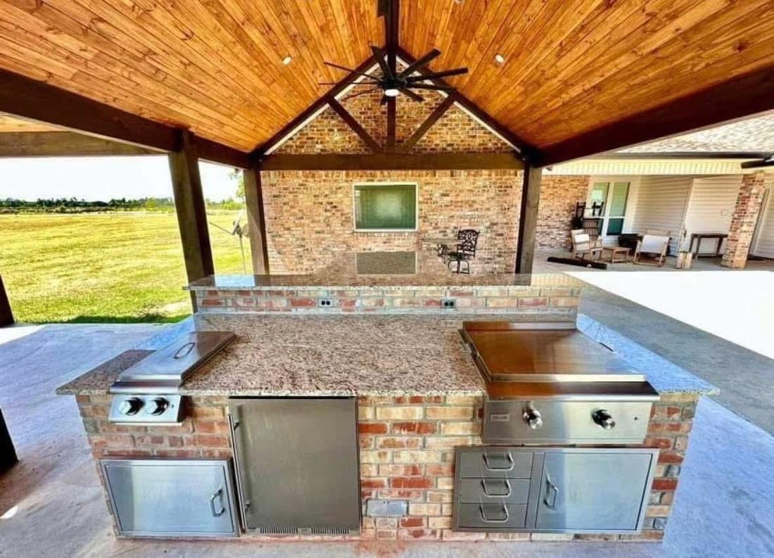 Brick outdoor kitchen under a hip roof pavilion built in Ascension Parish, Louisiana